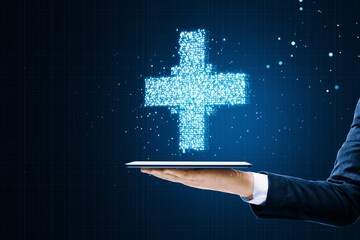 Poster - Professional holding a tablet projecting a bright digital plus sign, modern medical background concept