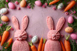 Easter celebration concept. Top view photo colorful easter eggs bunny ears backing molds and carrots on isolated pastel pink background with blank space