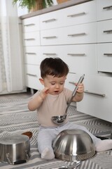 Wall Mural - Cute little boy with cookware at home