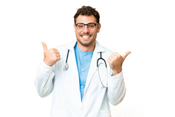 Wall Mural - Brazilian doctor man over isolated chroma key background with thumbs up gesture and smiling