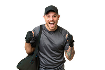 Poster - Young sport man with sport bag over isolated chroma key background celebrating a victory in winner position