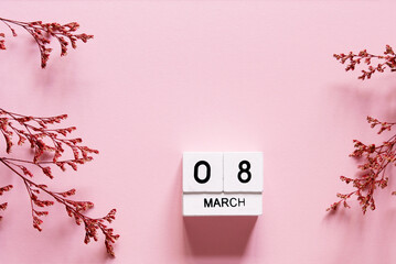 Wall Mural - 8 march wooden calendar with flowers on the pink background. Women's day composition. Copy space, top view	