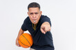 © Mdv Edwards - An irate middle-aged basketball coach or referee in casual attire holding a ball blowing a whistle, calling a foul. Isolated on a white background.