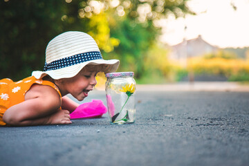 Wall Mural - A child catches a butterfly in nature. selective focus.