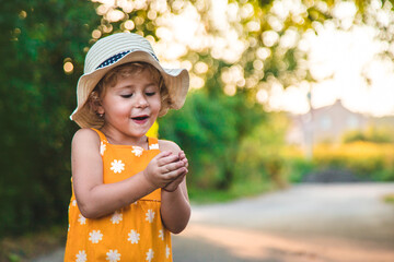 Wall Mural - A child catches a butterfly in nature. selective focus.