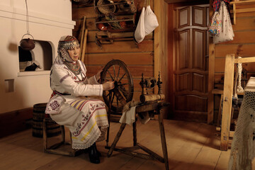 Wall Mural - portrait of a woman in national Chuvash clothes in the interior of a Chuvash dwelling in the national Museum