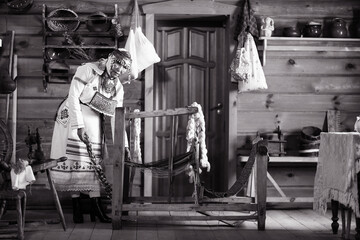 Wall Mural - portrait of a woman in national Chuvash clothes in the interior of a Chuvash dwelling in the national Museum