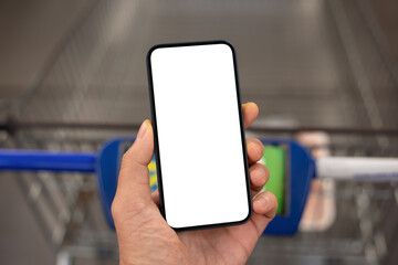 male hand hold phone with isolated screen over shopping cart