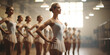 Beautiful ballerina looking at camera while standing in dance class