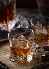 Wall Mural - Glasses of whiskey with ice on rustic wooden tray