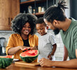 © Lumos sp - child family kitchen food boy son father mother watermelon fruit slice summer organic meal fun preparing healthy diet eating home black