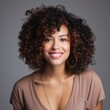© Adobe Contributor - Portrait of a smiling young woman with curly hair