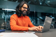 © Prostock-studio - Successful bearded indian guy project manager sitting at workdesk