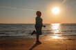 © ksenija1803z - Happy little laughing girl 7 years running on beach playing with dad at sunset