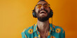 hipster funky male man with headphones smiling while listening music standing against on color background with copy space