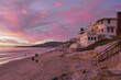 Ocean front beachside homes sunset dusk with purples and pinks, as seen from Oak Street Beach in Laguna Beach, California.