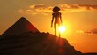 An alien silhouette against the setting sun on a pyramid hinting at ancient alien theories