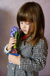 Little Girl holding hyacinth in flower pot.