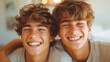 Two identical twin brothers. Portrait of teenage brother twins. Happy and laughing.