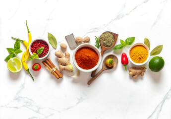 Poster - Food cooking ingredients background with various herbs and spices on white marble background top view