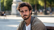 © brillianata - Attractive Italian guy with long hair and stubble sits on street bench