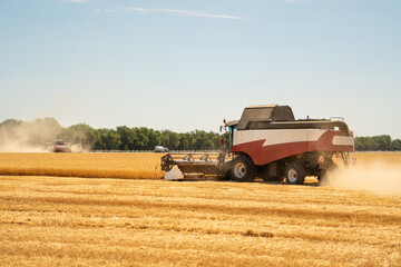 Combine harvester on the wheat field