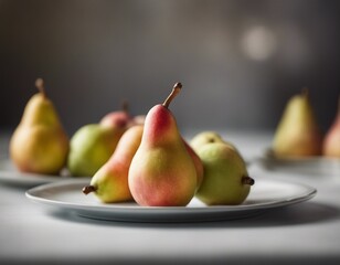 Four Fresh Pears on a White Plate
