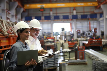 Wall Mural - worker or engineer working in factory with safety uniform , safety hat and safety glasses , image is safety concept or happy workplace