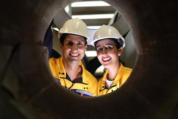 worker or engineer working in factory with safety uniform , safety hat and safety glasses , image is safety concept or happy workplace