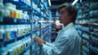 A man in a lab coat is examining bottles of medication on a pharmacy shelf