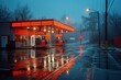 In the wet winter night, a red-lit gas station reflects in the water as rain falls upon the city streets, with a lone tree standing guard against the dark sky