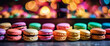 Brightly Colored Macarons in a Shadowy Display, the colors standing out in the dim light