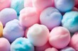 numerous colorful soft, fluffy cotton candy balls in pastel colors background, colorful pompons. sweets, softness, comfort, skincare,beauty products packaging backgrounds concept.