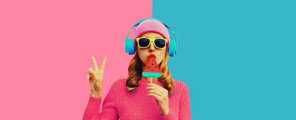 stylish cool young woman in headphones listening to music on colorful background