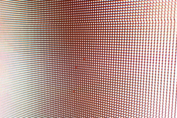 Abstract light gradient texture displayed on an LED screen with red color palette, creating visually dynamic abstract background texture.