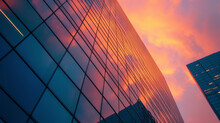 The Orangepink Sky Reflecting Off The Sleek Gl Windows Of A Highrise Office Building.