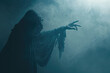 Grim reaper or Death reaching for his victim over dark foggy