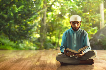 Canvas Print - Young asian muslim man with beard reading holy book quran at home