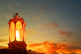 Fototapeta Sport - Arabic lantern on top rock mountain at beautiful sunset sky with cloud, Ramadan kareem background