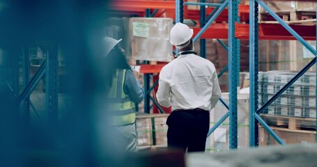 Canvas Print - Man, woman and walking in warehouse for inspection of package or supply chain logistics, tablet or storage. Colleagues, clipboard and checklist as factory distribution or shipping, delivery or parcel