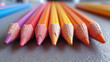 several nicely sharpened wooden colored pencils lie on a table next to each other where the perspective from one sharpened end to the other diminishes