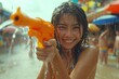 Happy young people are using water guns play in the summer, enjoy the splashing Songkran Festival