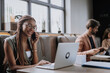 © Halfpoint - Beautiful businesswoman making phone call in modern office. Group of freelancers working in shared work area. Concept of coworking, common workspaces for business, startups.