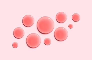 round drops of serum gel texture cosmetic products on a light pink background top view