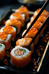Fototapete - The California Sushi roll set with salmon, vegetables, flying fish roe and caviar closeup. Japanese restaurant menu. Man eating sushi with chopsticks.