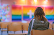  Individual Contemplating in a Room with a Rainbow Flag Symbolizing Inclusive Faith