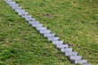 © aquatarkus - Concrete steps on green grass, stone staircase on a grassy slope