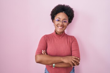 Canvas Print - Beautiful african woman with curly hair standing over pink background happy face smiling with crossed arms looking at the camera. positive person.