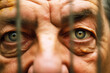 closeup of prisoners eyes behind a fence
