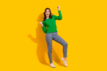 Poster - Full body size photo of charming overjoyed young positive girl champion yeah screaming raise fists up isolated on yellow color background